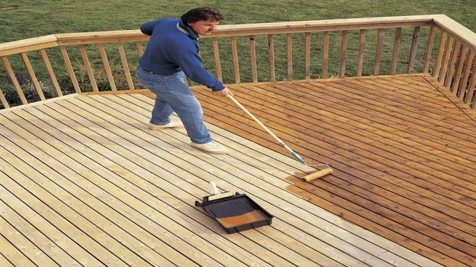 when to stain a new deck