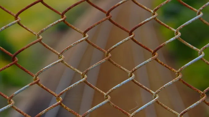 when was the chain link fence invented